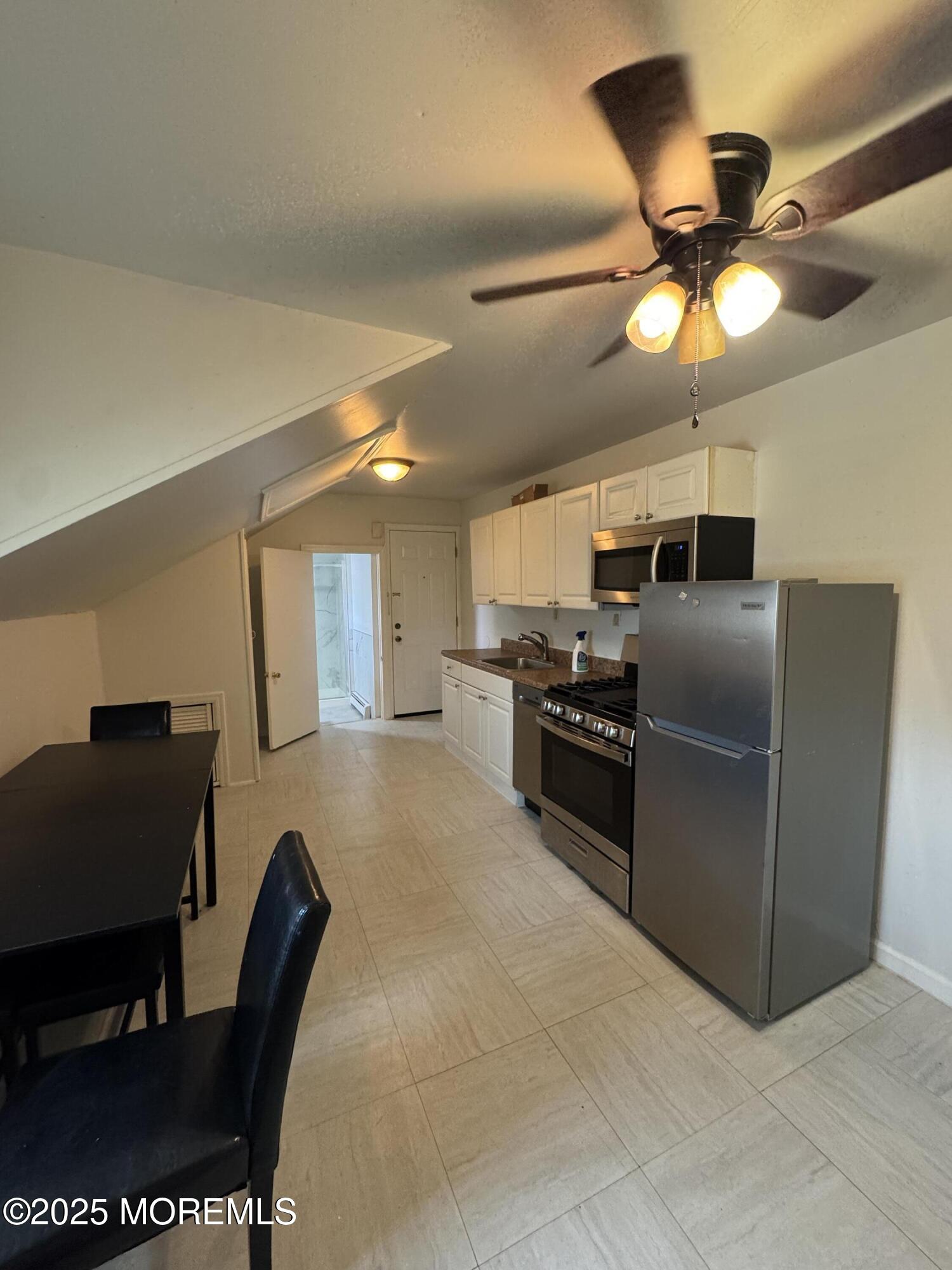 172 Carr Avenue, Unit D Keansburg, NJ 07734 - Photo 3 of 12 a kitchen with stainless steel appliances granite countertop a refrigerator and a stove top oven