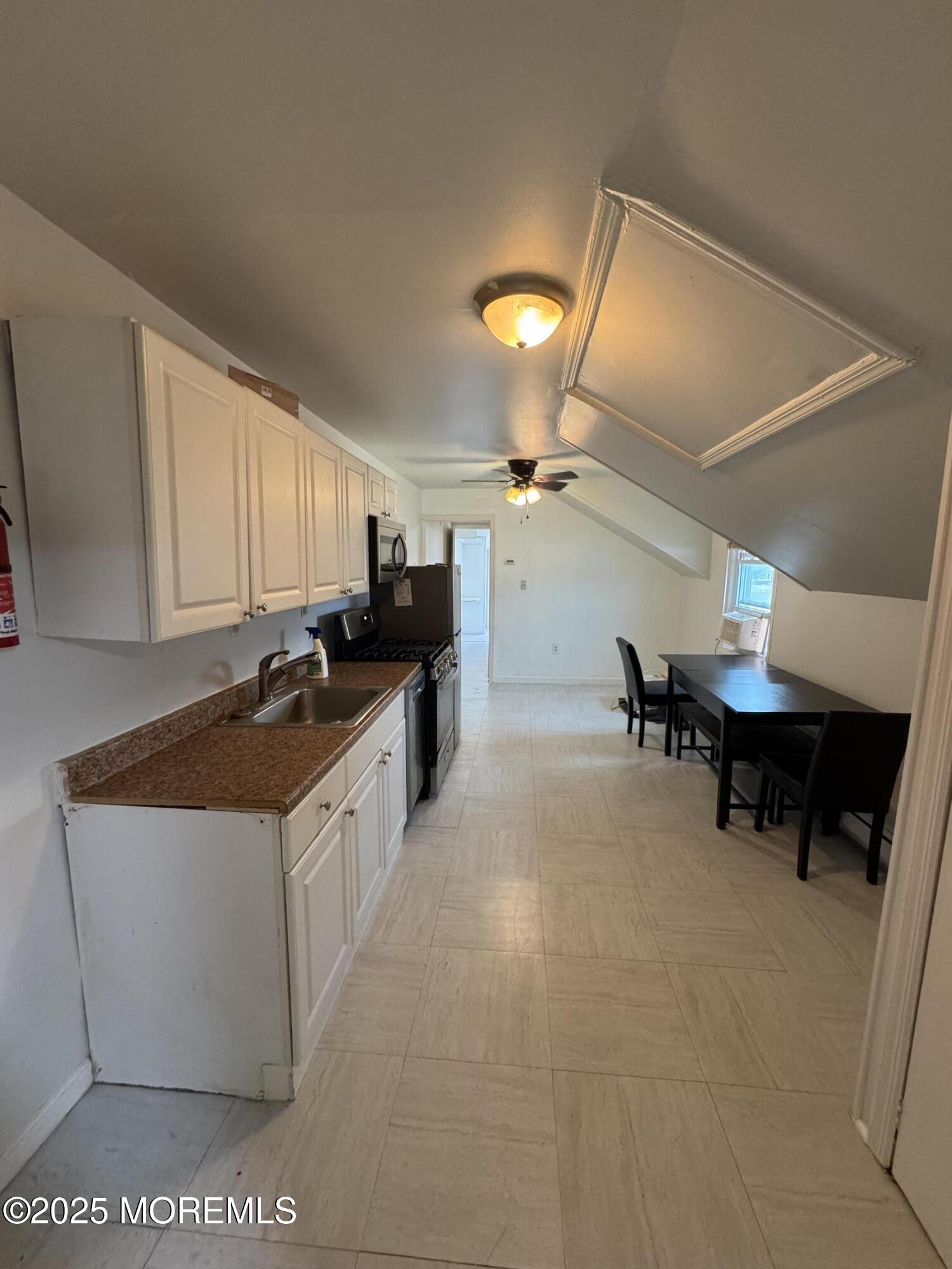 172 Carr Avenue, Unit D Keansburg, NJ 07734 - Photo 4 of 12 a kitchen with a sink and cabinets