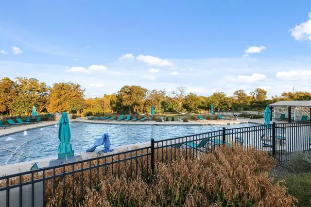 a view of swimming pool with a table and chairs