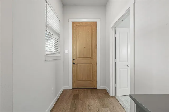 a view of a room with wooden floor and closet