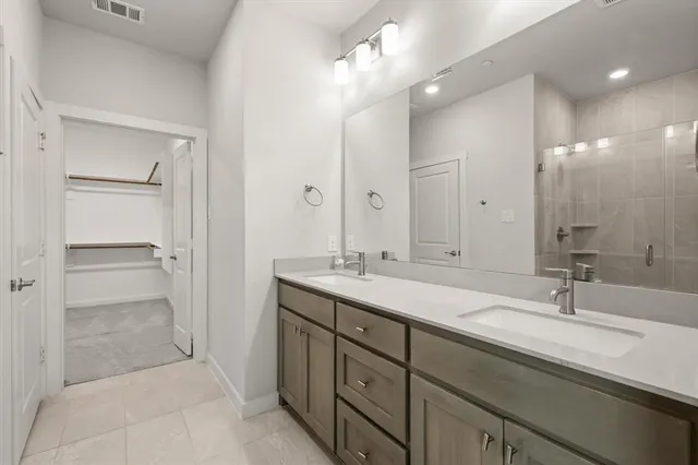 a bathroom with a sink double vanity and a mirror
