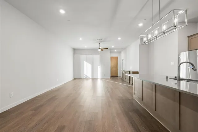 a view of a kitchen with a sink and wooden floor