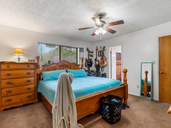 a bedroom with a bed and a dresser