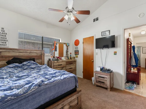 a bedroom with a bed and a flat screen tv