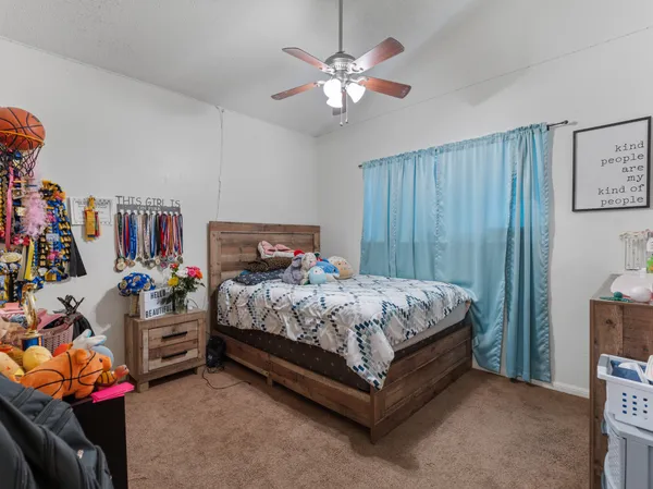 a bedroom with bed and a chandelier