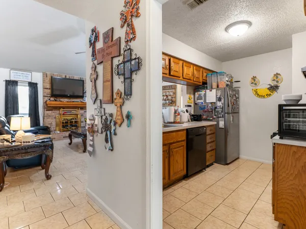a kitchen with refrigerator and cabinets
