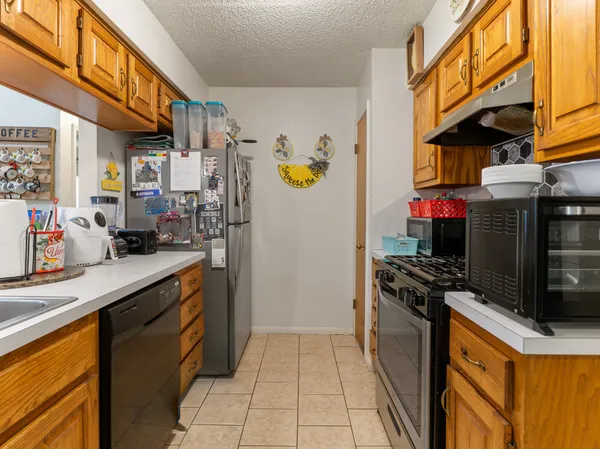 a kitchen with refrigerator and cabinets