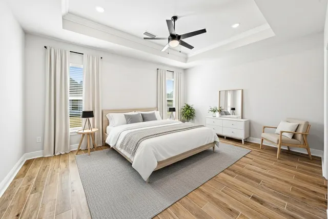 a bedroom with a large bed couch and a window