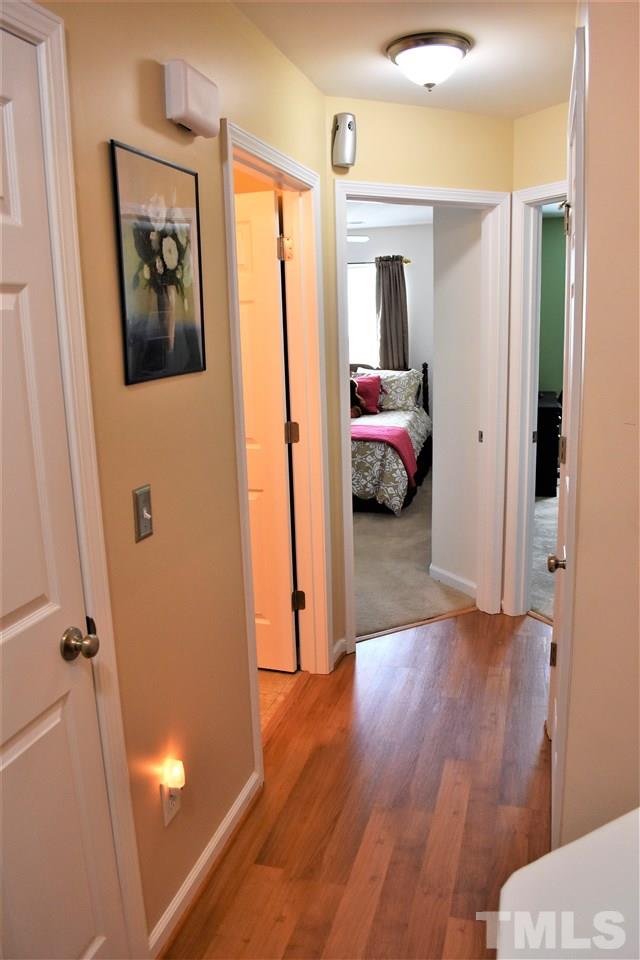 351 Gilman Lane, Unit 102 Raleigh, NC 27610 - Photo 8 of 18 This hallway leads to the laundry room, full bathroom and two bedrooms with WIC!