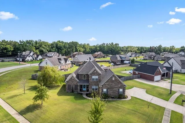 a aerial view of a house with swimming pool and big yard