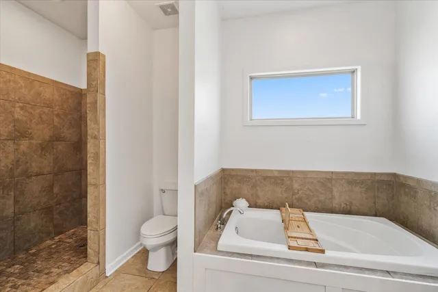 a bathroom with a bathtub and toilet