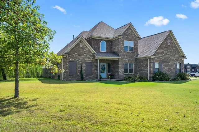 a front view of a house with a yard