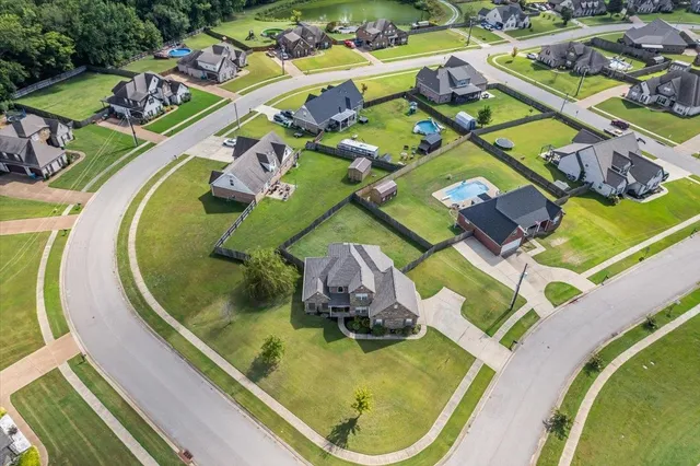 an aerial view of a swimming pool with outdoor seating