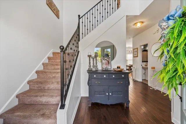 a view of entryway and hall with wooden floor