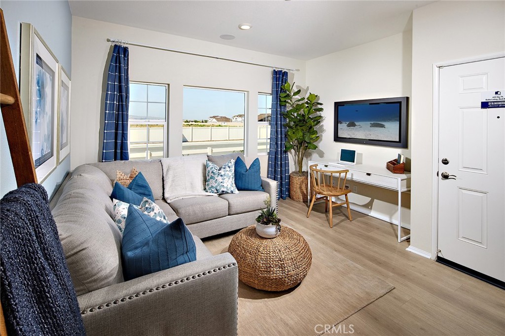 2090 El Nido Avenue Perris, CA 92571 - Photo 15 of 19 a living room with furniture and a flat screen tv