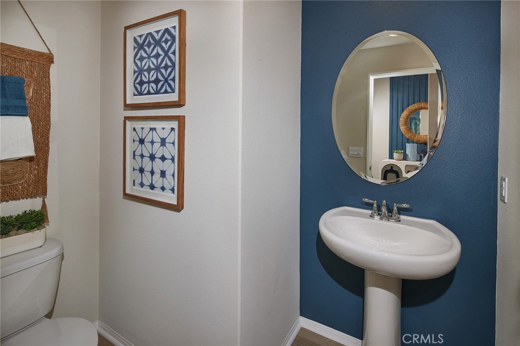 2090 El Nido Avenue Perris, CA 92571 - Photo 8 of 19 a bathroom with a toilet sink and mirror