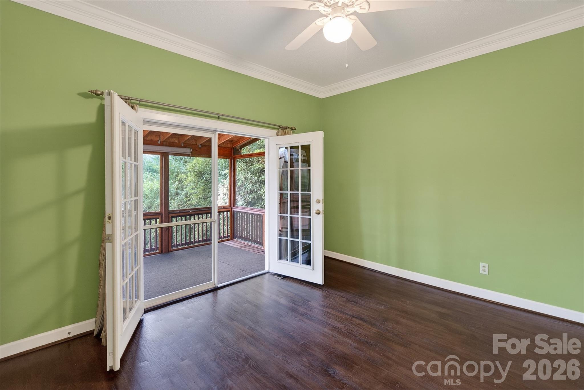 56 Whitney Avenue Tryon, NC 28782 - Photo 11 of 35 an empty room with wooden floor and fan