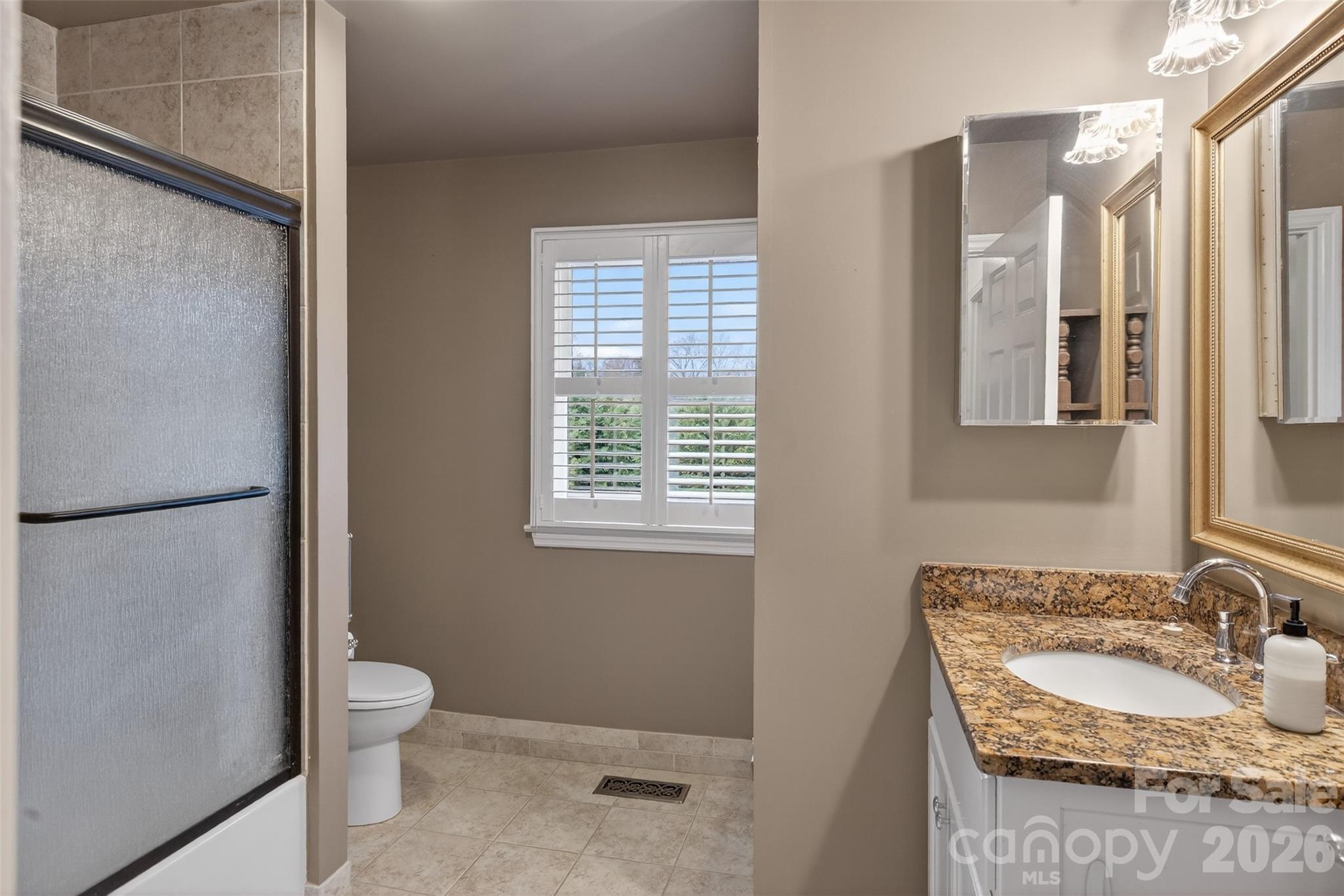 56 Whitney Avenue Tryon, NC 28782 - Photo 14 of 35 a bathroom with a granite countertop sink toilet and shower