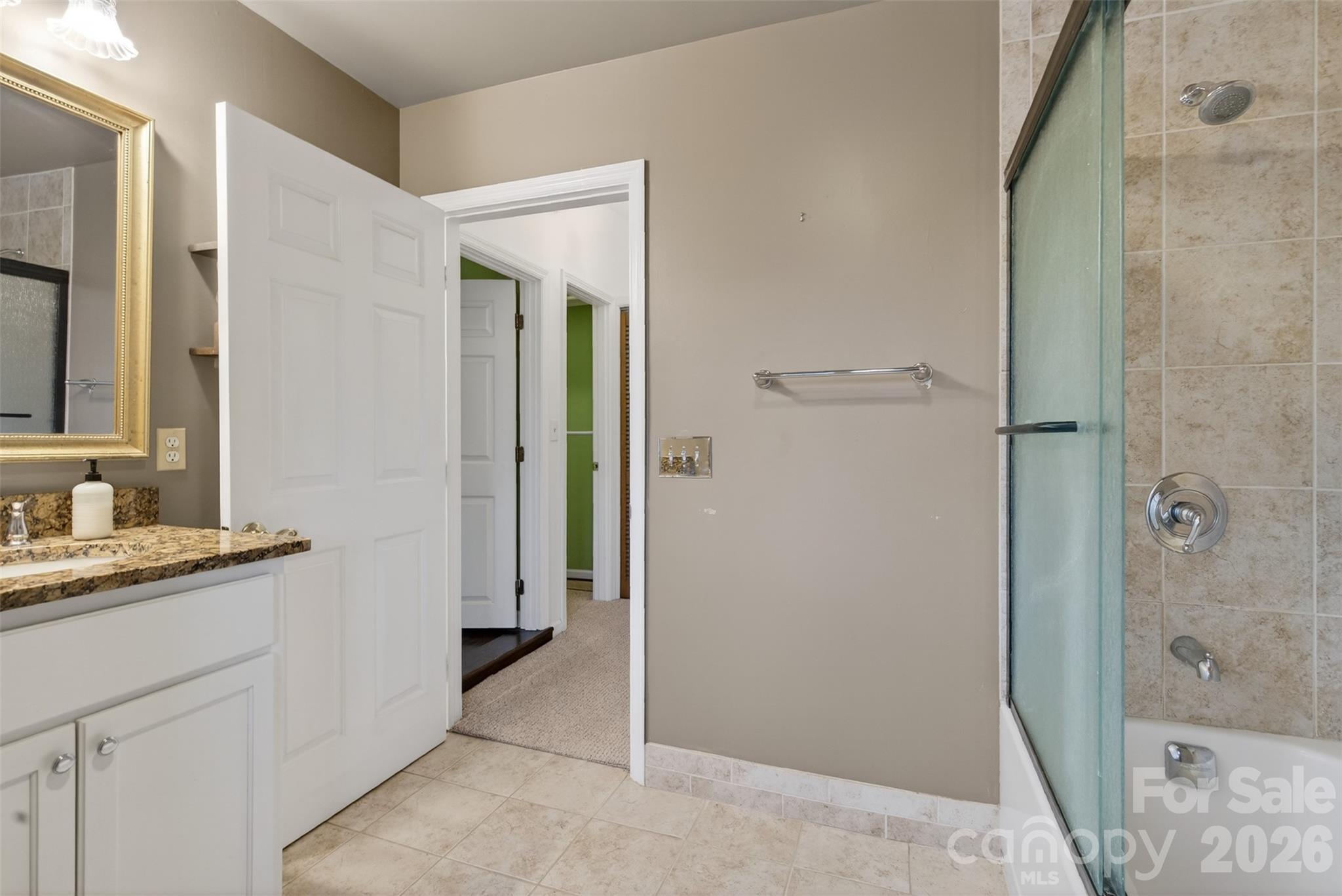 56 Whitney Avenue Tryon, NC 28782 - Photo 15 of 35 a bathroom with a granite countertop sink mirror and shower