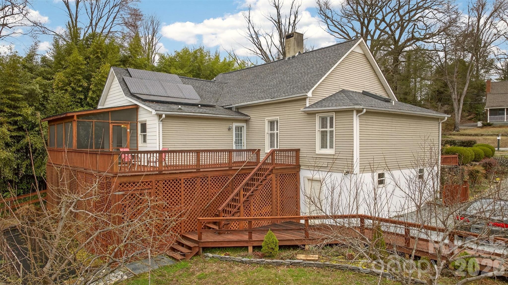 56 Whitney Avenue Tryon, NC 28782 - Photo 22 of 35 a small white house with a white roof and table and chairs