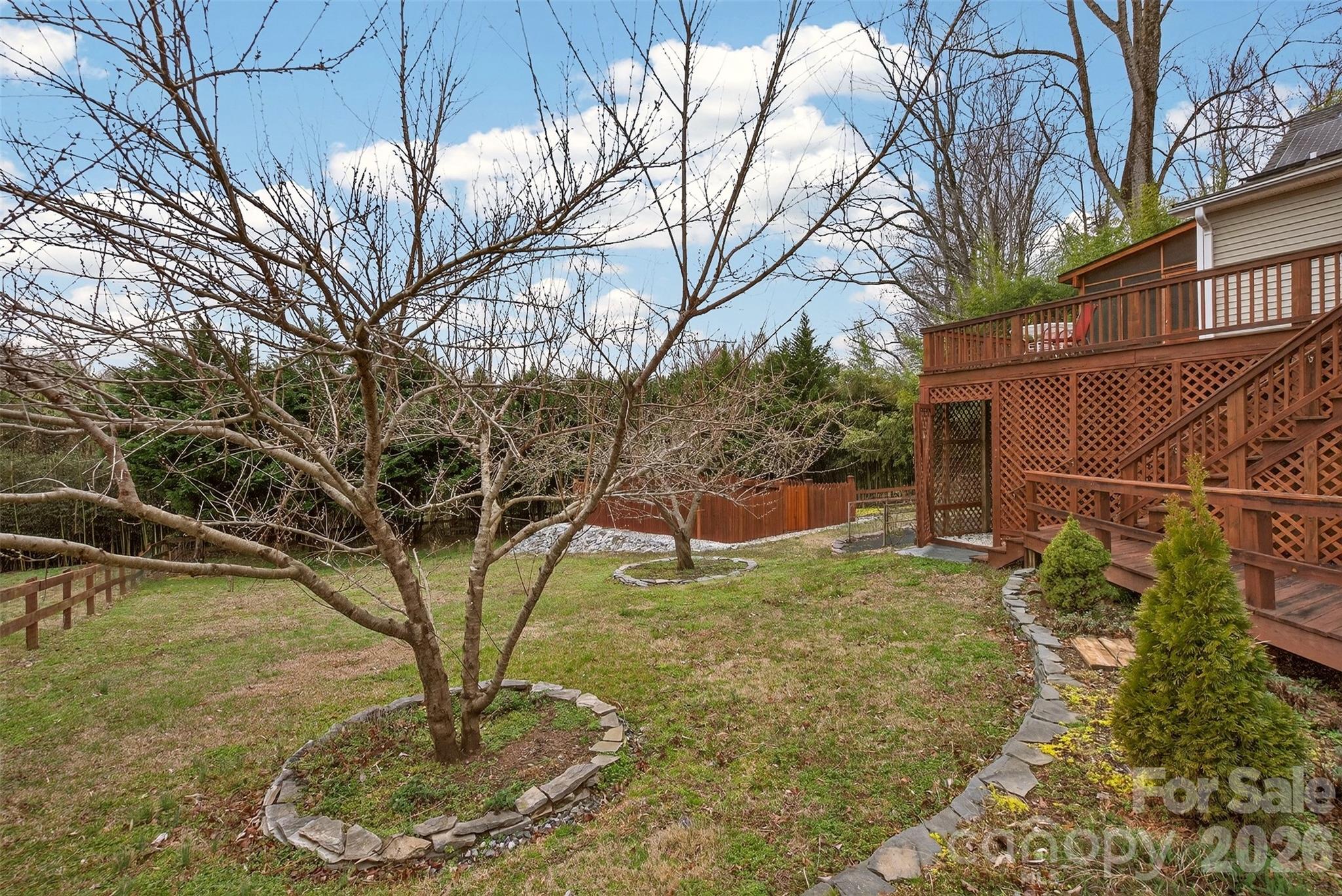 56 Whitney Avenue Tryon, NC 28782 - Photo 24 of 35 a backyard of a house with lots of green space