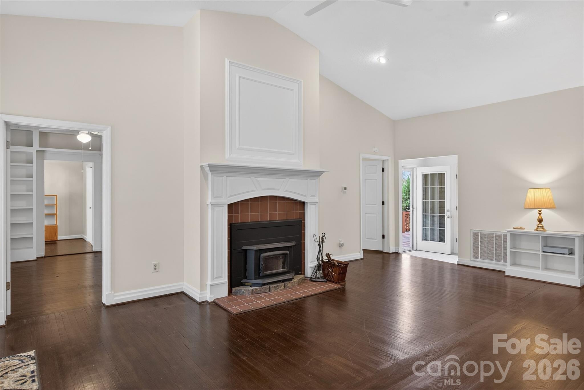 56 Whitney Avenue Tryon, NC 28782 - Photo 3 of 35 a view of an empty room with wooden floor fireplace and a window