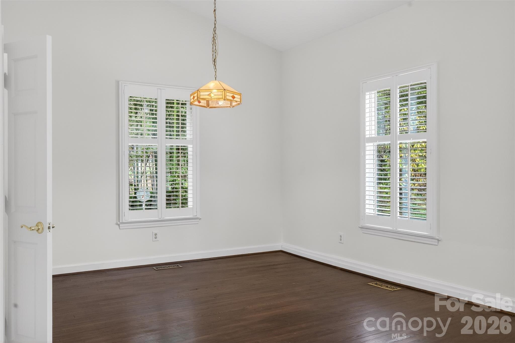 56 Whitney Avenue Tryon, NC 28782 - Photo 5 of 35 an empty room with wooden floor and window