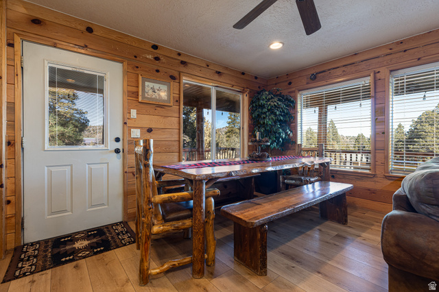1505 West Elk Ridge Drive Alton, UT 84710 - Photo 2 of 53 Dining area with a textured ceiling, wooden walls, wood-type flooring, a ceiling fan, and recessed lighting