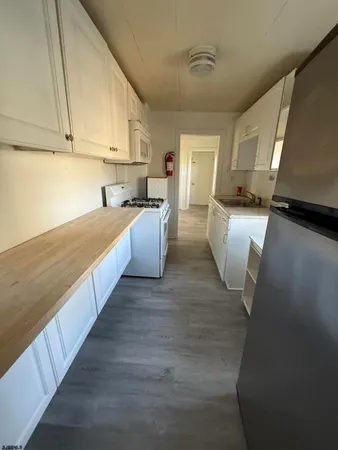 a stove top oven sitting inside of a kitchen
