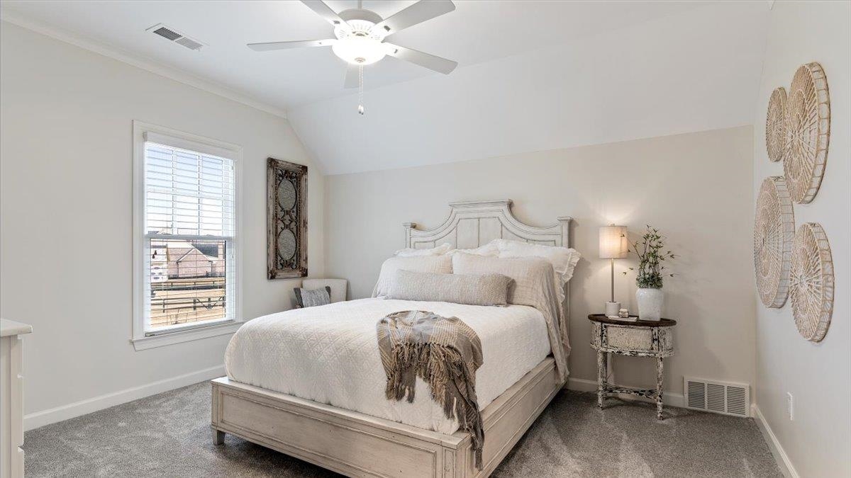 25 Jay Cove Piperton, TN 38017 - Photo 26 of 39 a bedroom with a bed and a chandelier