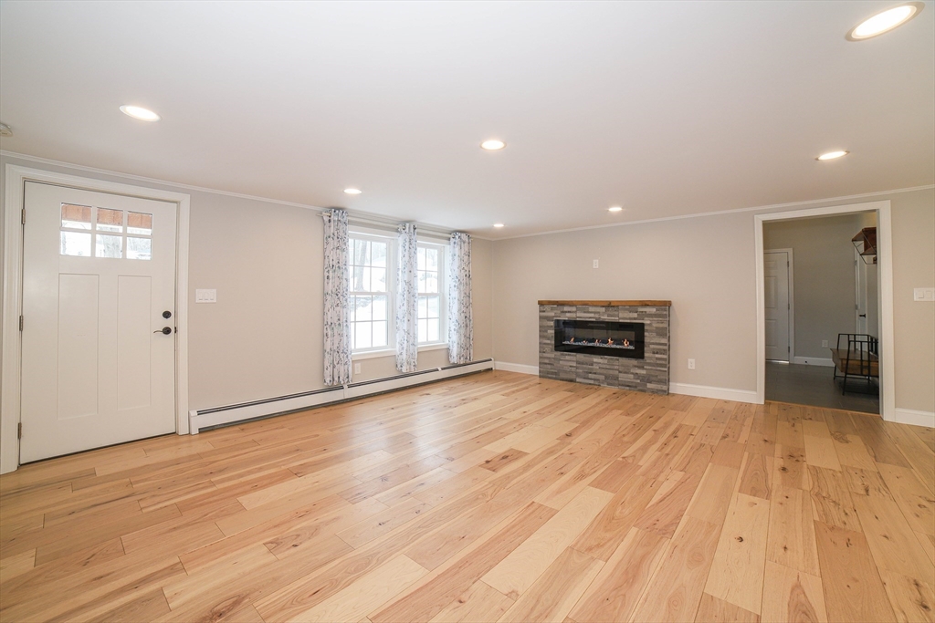 3 Woods Road Westminster, MA 01473 - Photo 11 of 42 a view of empty room with wooden floor and fireplace