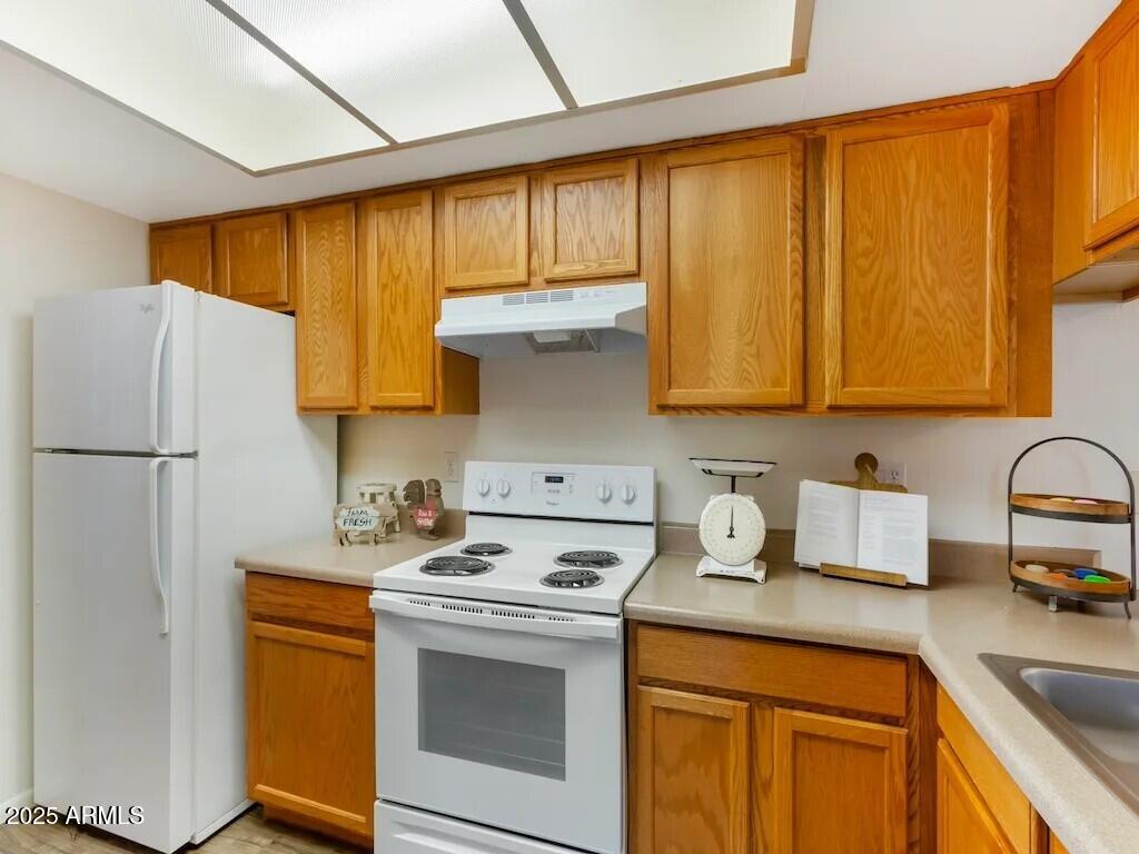 164 North 74th Street, Unit 2 Mesa, AZ 85207 - Photo 5 of 14 a kitchen with stainless steel appliances granite countertop a sink stove and refrigerator