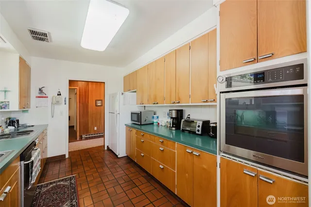 a dining room with furniture a flat screen tv and floor to ceiling window