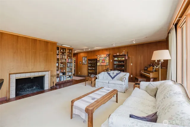 a living room with furniture and a floor to ceiling window