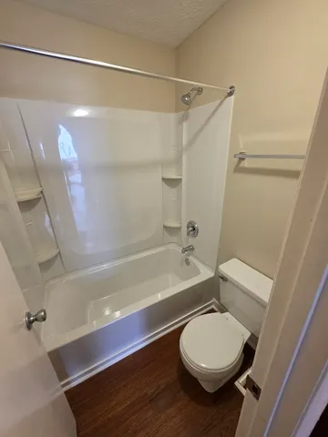 a bathroom with a toilet and a shower