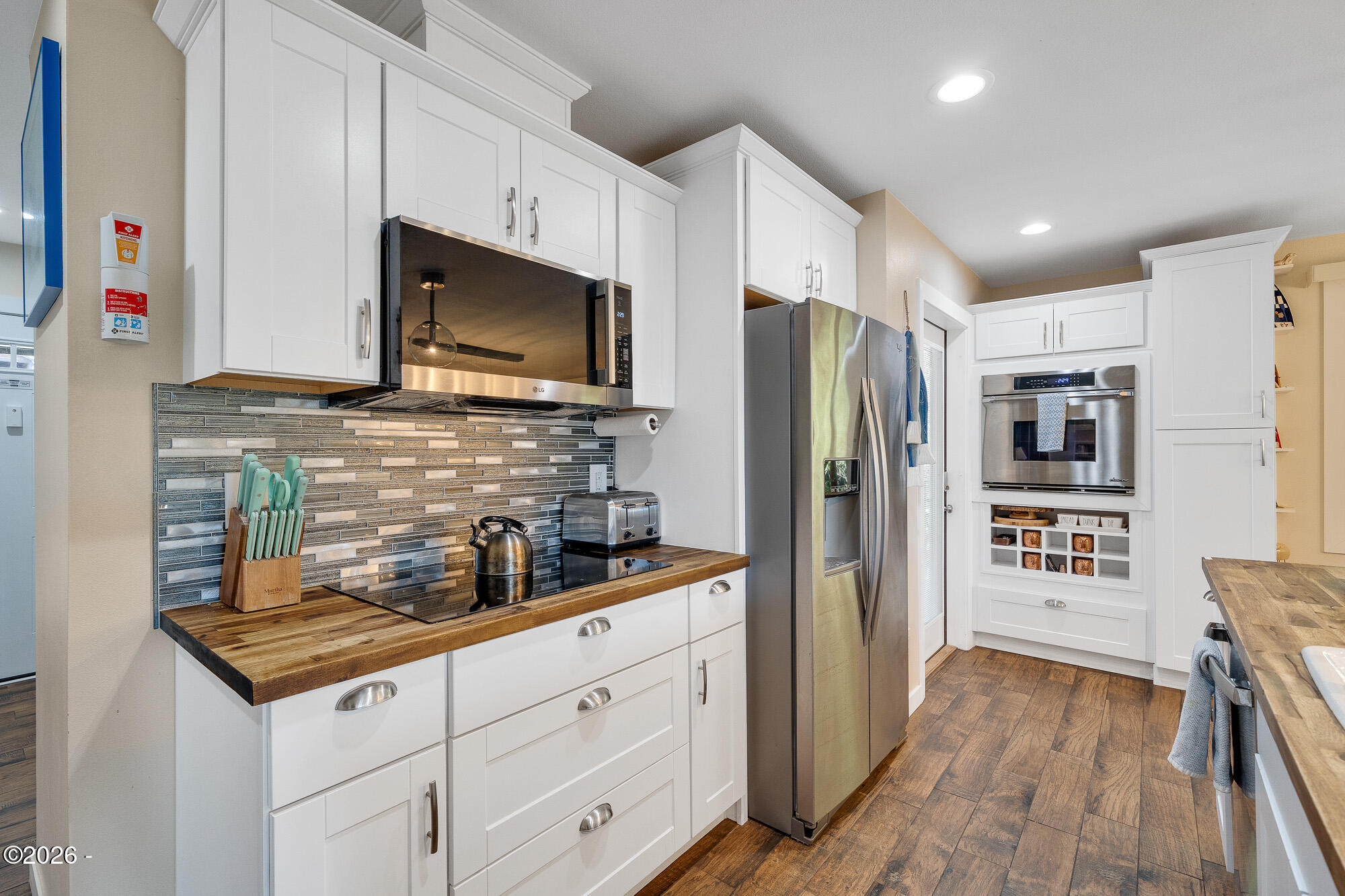 13150 D Street Nehalem, OR 97131 - Photo 8 of 29 a kitchen with stainless steel appliances microwave stove refrigerator and cabinets