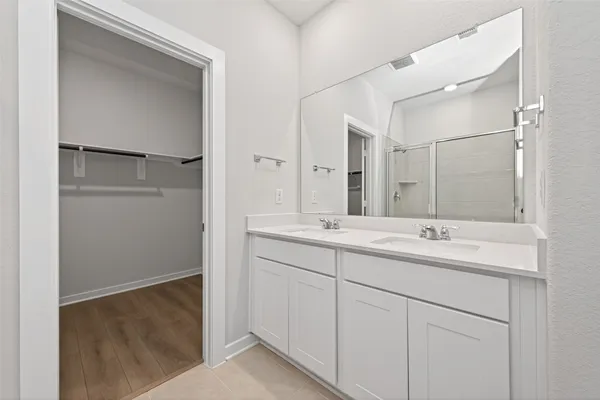 a bathroom with a double vanity sink and mirror