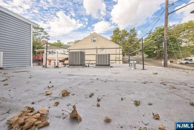 a view of a dry yard with a tree