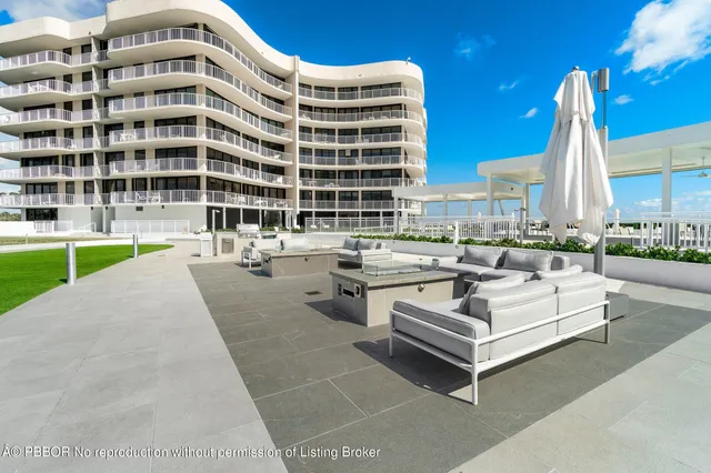 a view of a swimming pool with outdoor seating