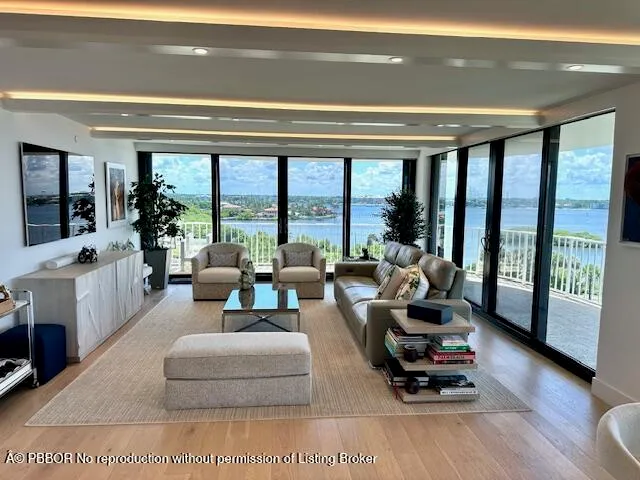 a living room with furniture and a floor to ceiling window