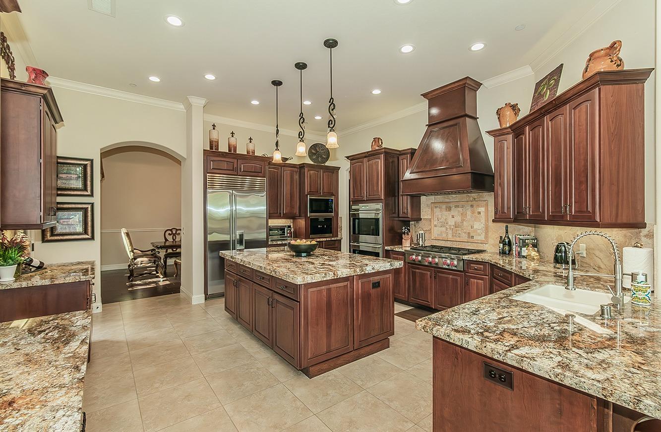 1807 North Rector Avenue Clovis, CA 93619 - Photo 13 of 55 a kitchen with kitchen island granite countertop wooden cabinets and a stove