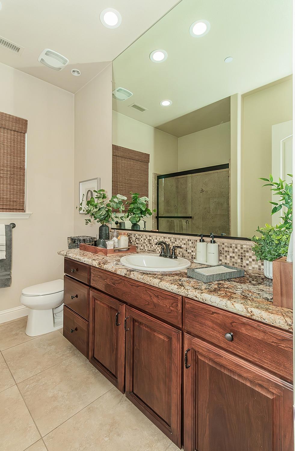1807 North Rector Avenue Clovis, CA 93619 - Photo 28 of 55 a bathroom with a granite countertop sink and a mirror