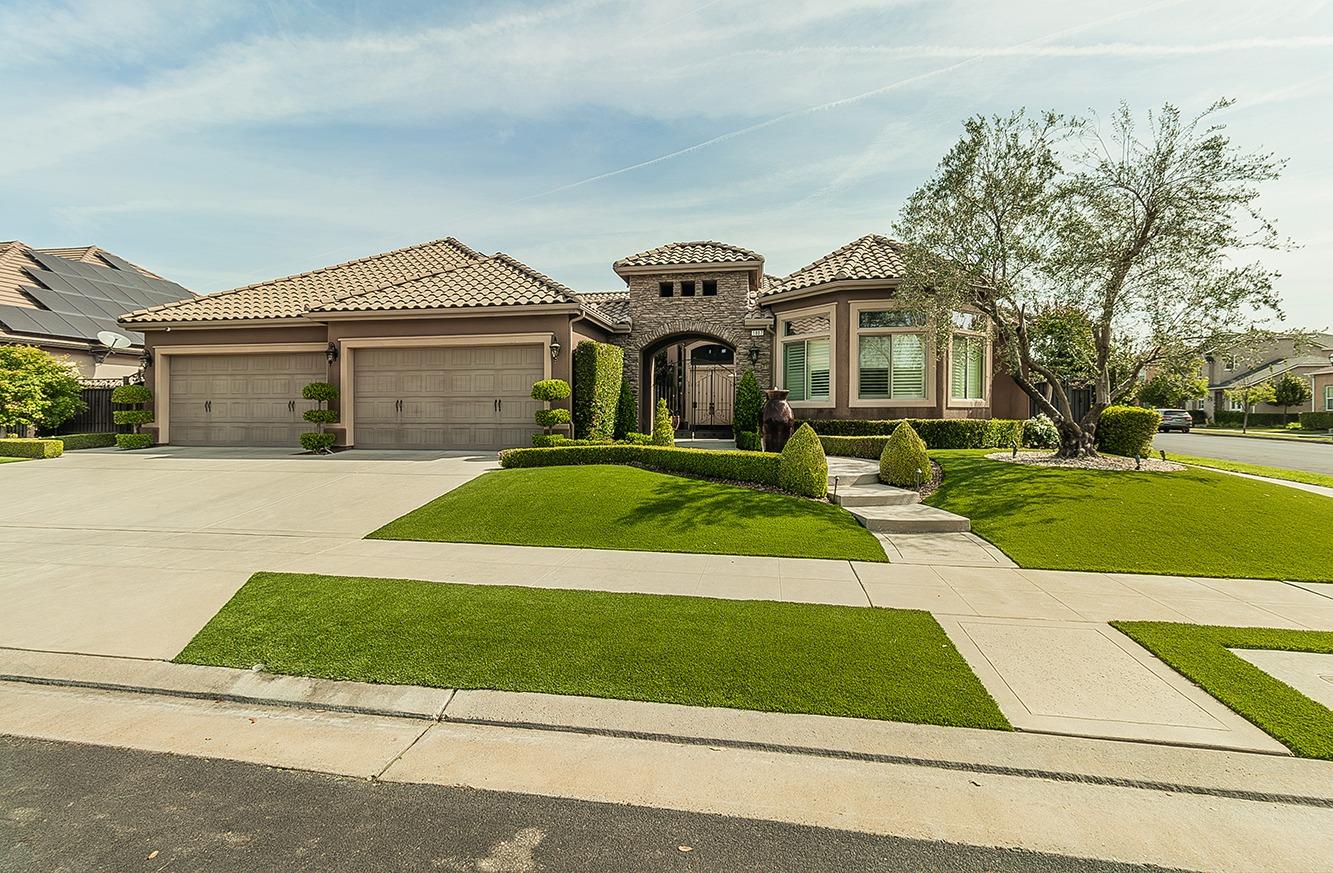 1807 North Rector Avenue Clovis, CA 93619 - Photo 42 of 55 a view of a white house with a big yard and potted plants