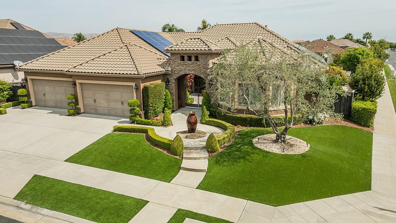 1807 North Rector Avenue Clovis, CA 93619 - Photo 48 of 55 a view of a white house with a big yard and potted plants