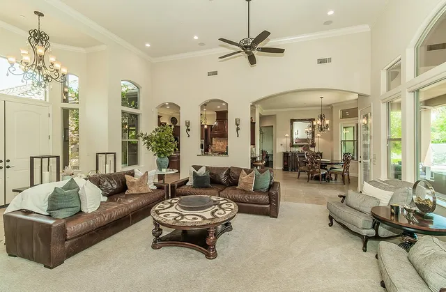 a living room with furniture ceiling fan and a rug