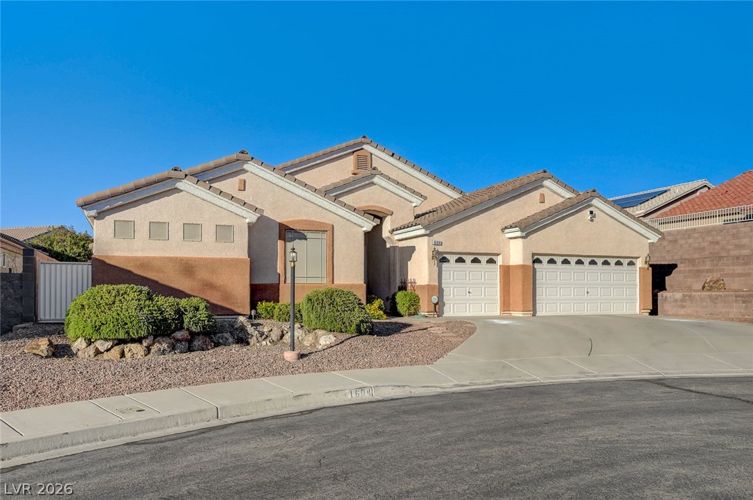 1604 Cattle Ranch Place Henderson, NV 89002 - Photo 97 of 99 A desert-friendly landscape surrounds this residence with attached garage parking and a distinctive architectural profile.