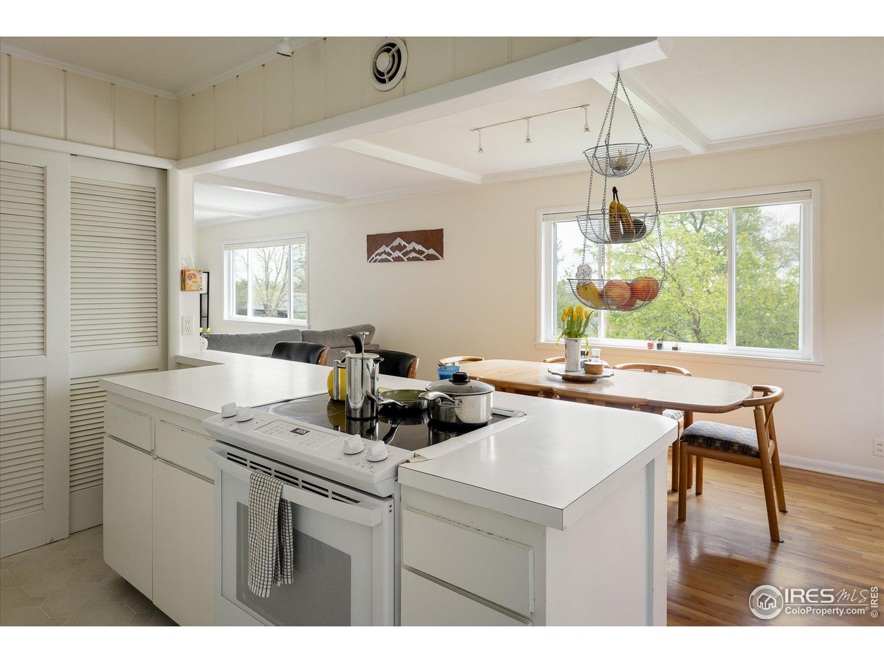 2855 4th Street Boulder, CO 80304 - Photo 10 of 37 a kitchen with a stove a refrigerator and a dining table