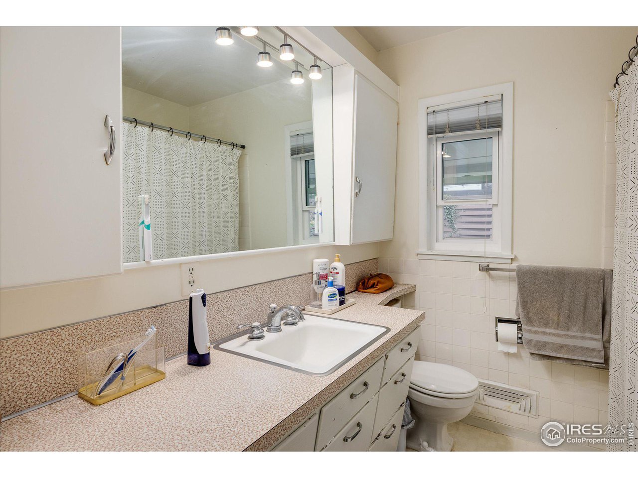 2855 4th Street Boulder, CO 80304 - Photo 16 of 37 a bathroom with a sink toilet a mirror and vanity