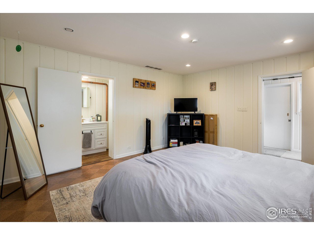2855 4th Street Boulder, CO 80304 - Photo 18 of 37 a large bedroom with a bed and a flat screen tv