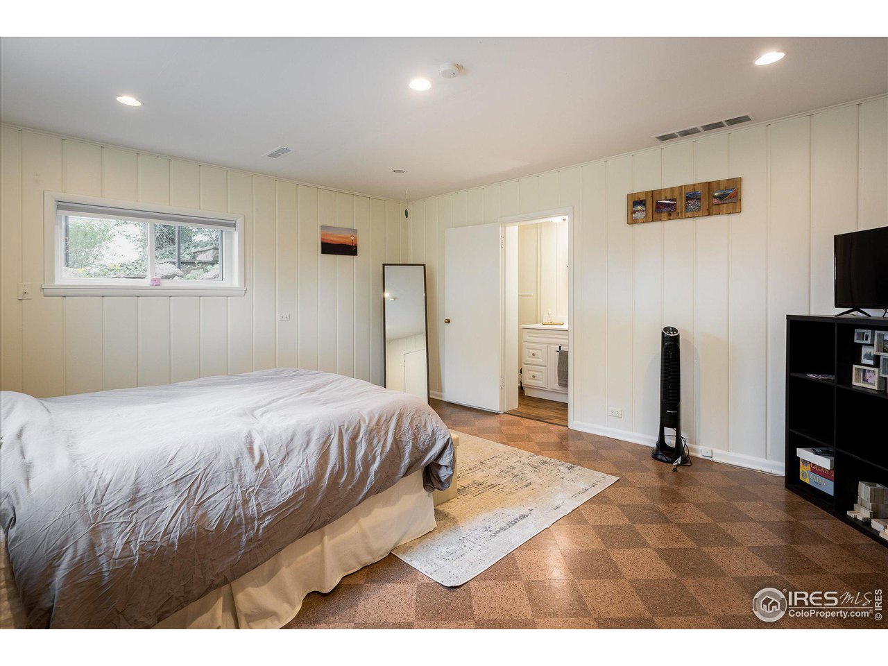 2855 4th Street Boulder, CO 80304 - Photo 19 of 37 a bedroom with a bed and a flat screen tv